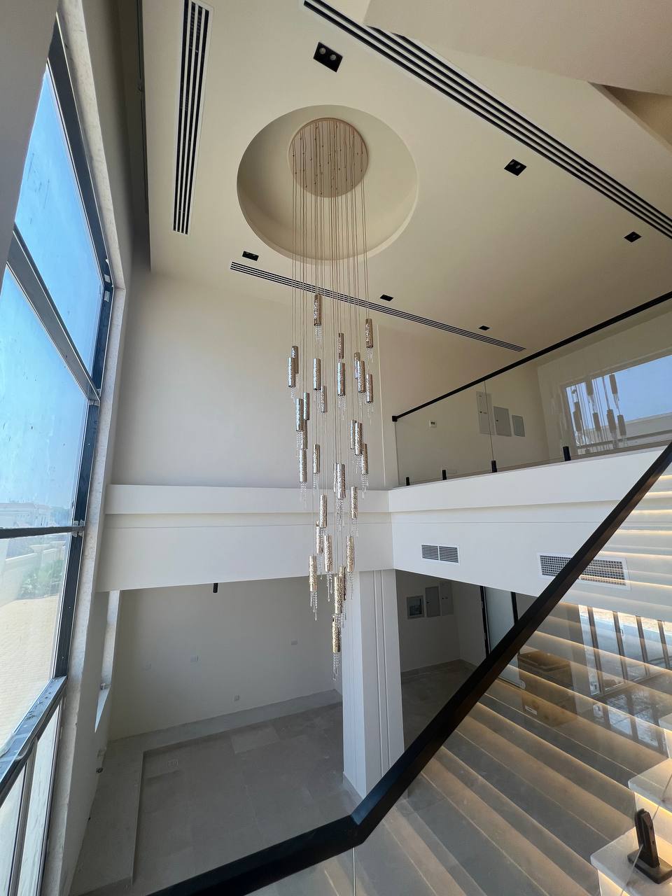 Staircase and chandelier detail in a finished interior